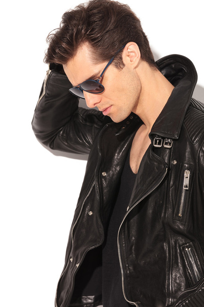 sad fashion man in leather jacket looking down - Photo, Image