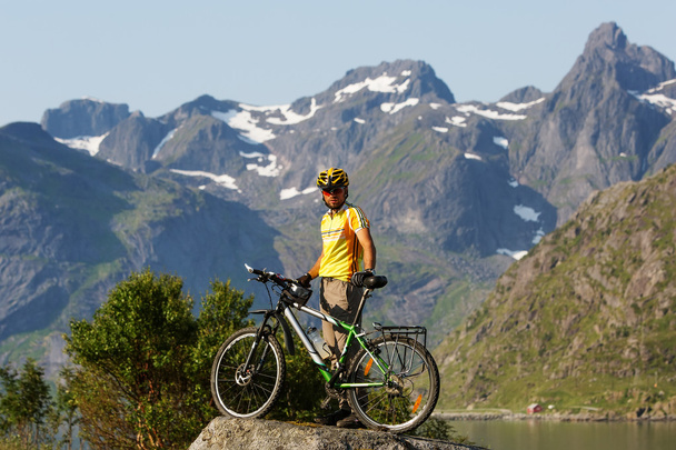 Biking in Norway against picturesque landscape - Foto, afbeelding