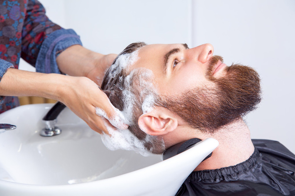 man having his hair washed in a hairdressing salon - Valokuva, kuva