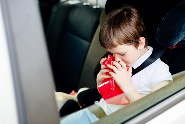 Seven years old child vomiting in car - Photo, Image
