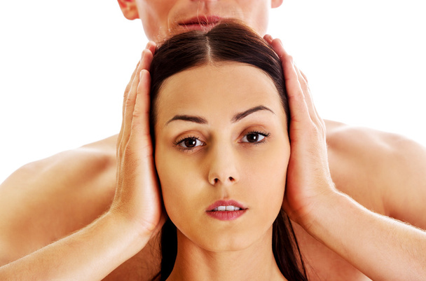 Man covering womens ears - Foto, immagini