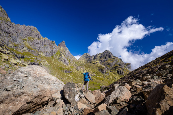 Man with backpack hiking in Caucasus mountains in Georgia - Fotó, kép