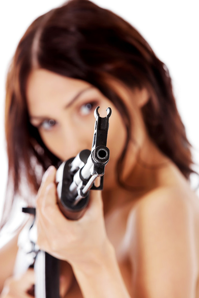 Sexy nude brunette girl model with weapon. - Foto, imagen