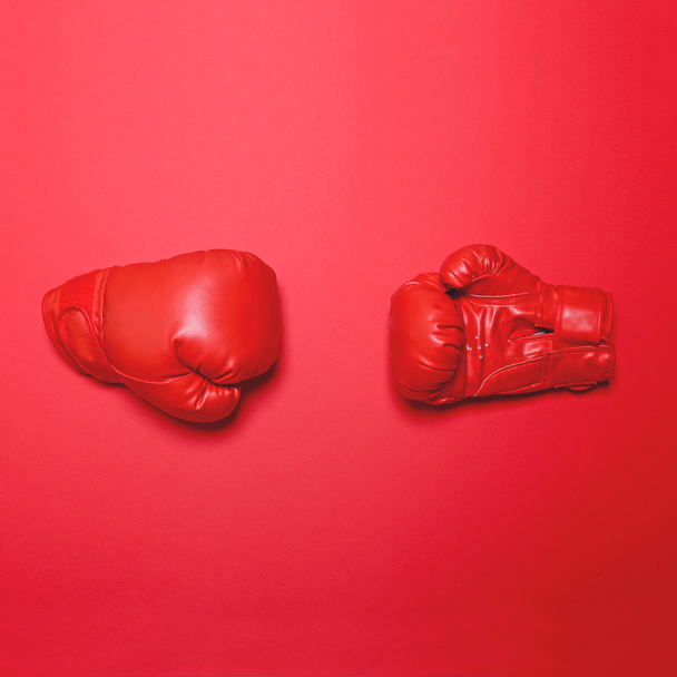 Pair of red boxing gloves on red background - Flat lay minimal d - Zdjęcie, obraz