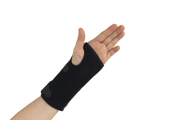 Hand in black wrist bandage with isolated. - Fotó, kép