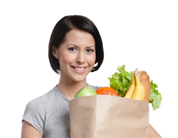 buźka dziewczyna trzyma pakietu warzyw - Zdjęcie, obraz