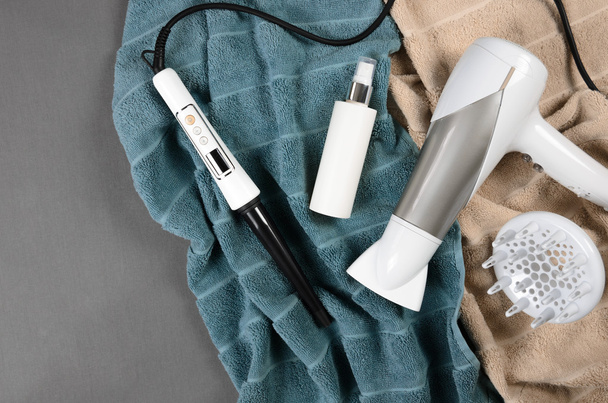 Hairstyling tools (white hairdryer, hairspray, cone curling wand - Fotó, kép