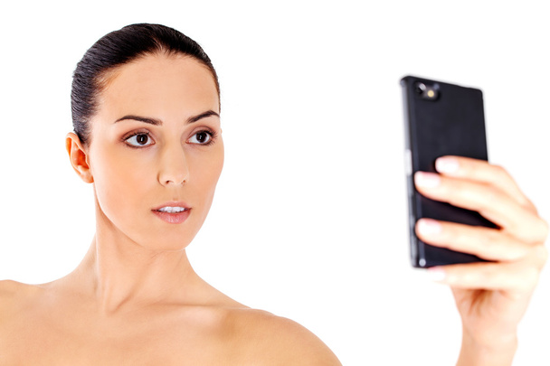Young nude woman taking selfie - Zdjęcie, obraz