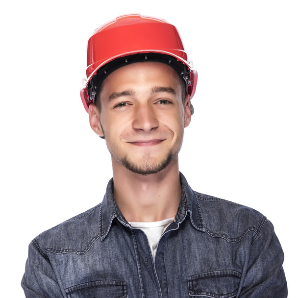 Young man in a construction helmet. - Valokuva, kuva