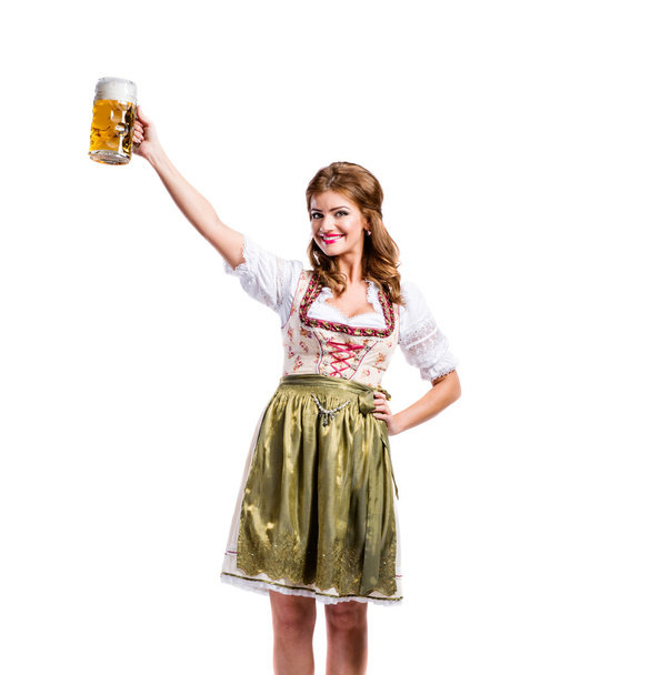 Woman in bavarian dress holding beer - Fotó, kép