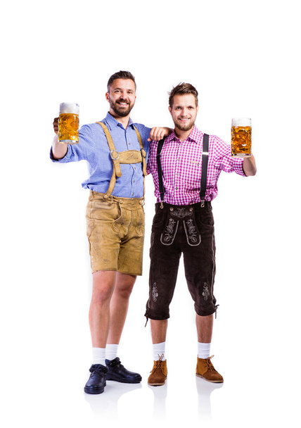 Men in bavarian clothes with mugs of beer - Fotografie, Obrázek