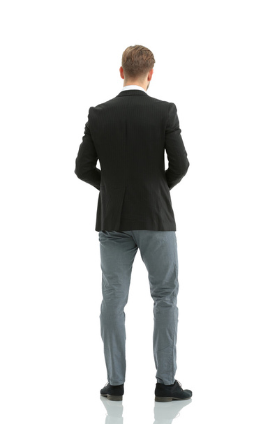 Businessman from the back - looking at something over a white ba - Zdjęcie, obraz