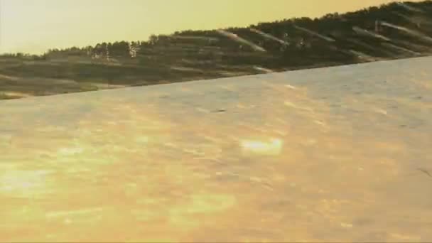 Wakeboarder girl in golden water splash, summer sunset - Кадры, видео