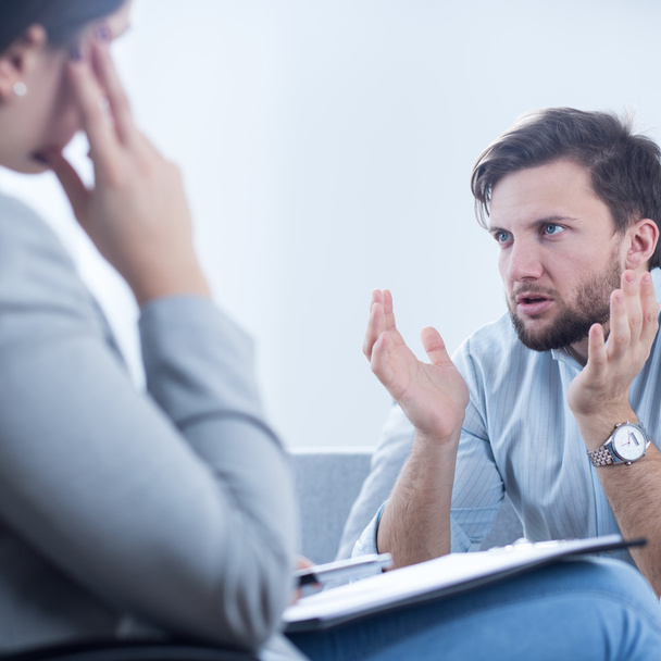 Angry man talking with psychiatrist - Φωτογραφία, εικόνα
