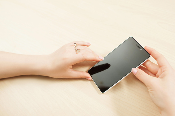 Female hands holding smartphone, customer pov - Photo, image