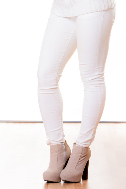 Winter fashion. Female legs in stylish shoes isolated - Фото, изображение