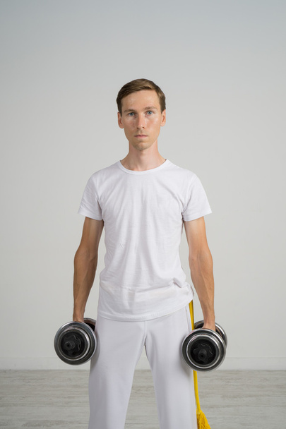 Young Man doing Exercise with Dumbbells. - Photo, Image