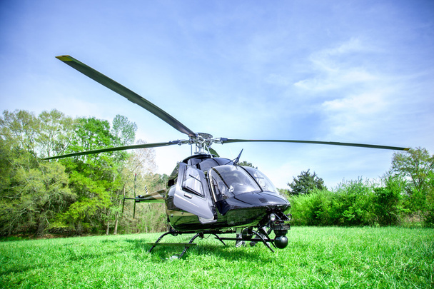 Black bell 407 helicopter getting ready to fly. - Photo, Image