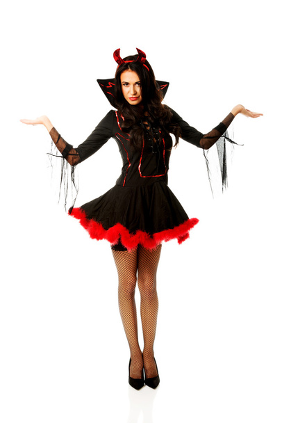 Woman in devil clothes with open hands gesture - Photo, image