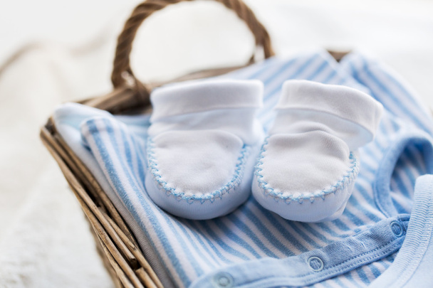 close up of baby clothes for newborn boy in basket - Φωτογραφία, εικόνα
