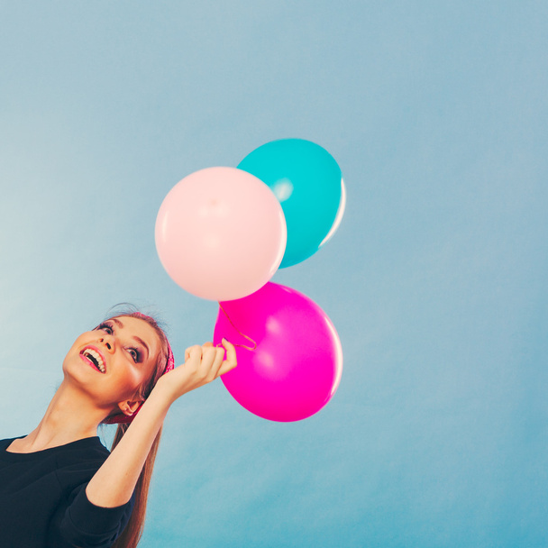 Smiling crazy girl having fun with balloons. - Zdjęcie, obraz