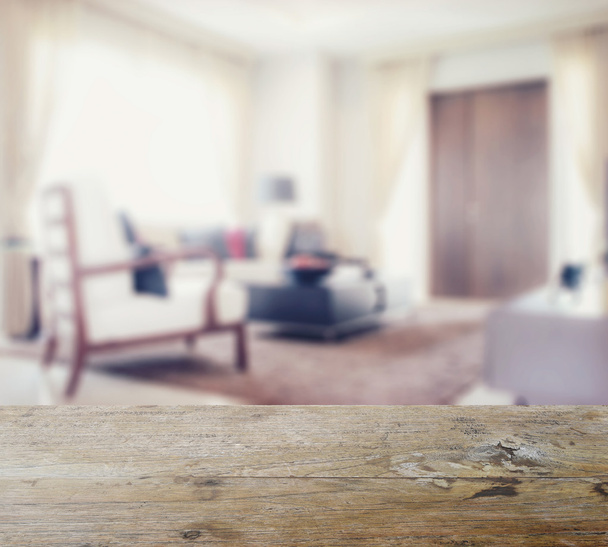 wooden table top with blur of modern living room interior - Foto, Imagen