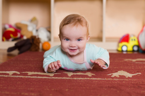 Baby playing and crawling, making faces,  on the floor. - Фото, зображення