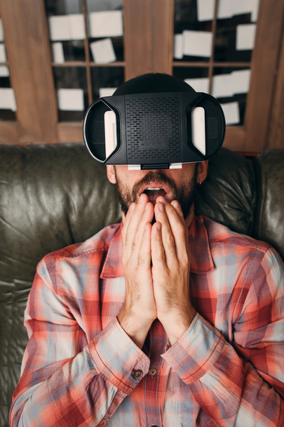 Shocked man with virtual reality glasses - Фото, изображение