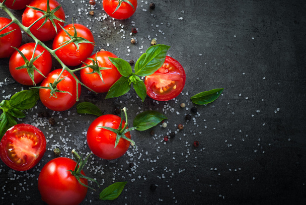Fresh cherry tomatoes on a black - Photo, image