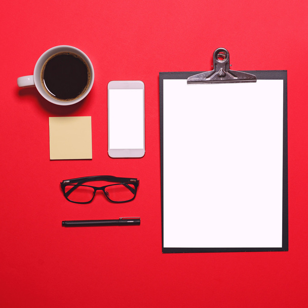 Flat lay of workplace in office with business accessories on red - Foto, immagini
