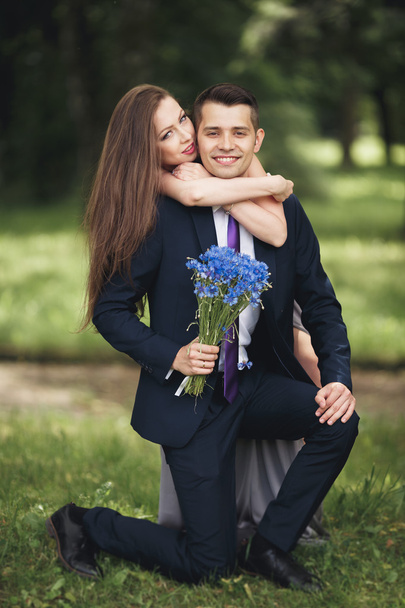 Handsome young couple posing outdoors after ceremony - 写真・画像