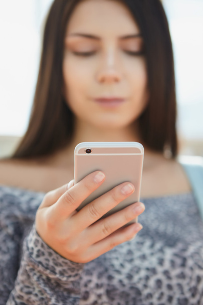 Brunette young girl using big silver modern smart phone  - Foto, immagini