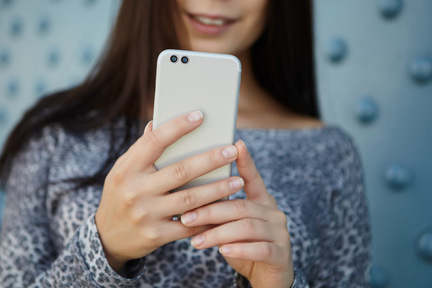 Girl taking photo with modern dual camera smart phone - Photo, Image