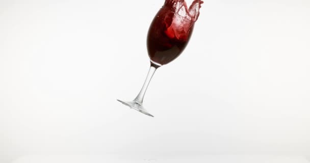 Kırmızı şarap düşen cam ve beyaz arka plan, yavaş hareket 4k Splashing - Video, Çekim