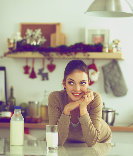 Smiling attractive woman having breakfast in kitchen interior - Photo, image