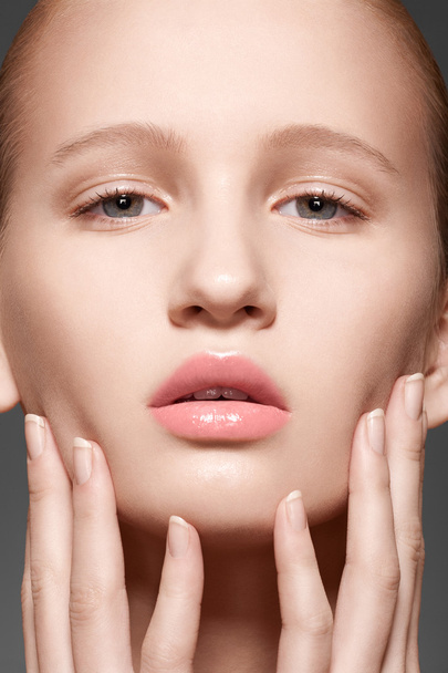 Make-up & cosmetics, manicure. Closeup portrait of beautiful woman model face with clean skin, full glossy lips. Natural skincare beauty, clean soft skin, french manicure - Fotó, kép