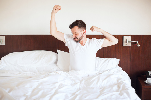  man waking up and stretching - Φωτογραφία, εικόνα