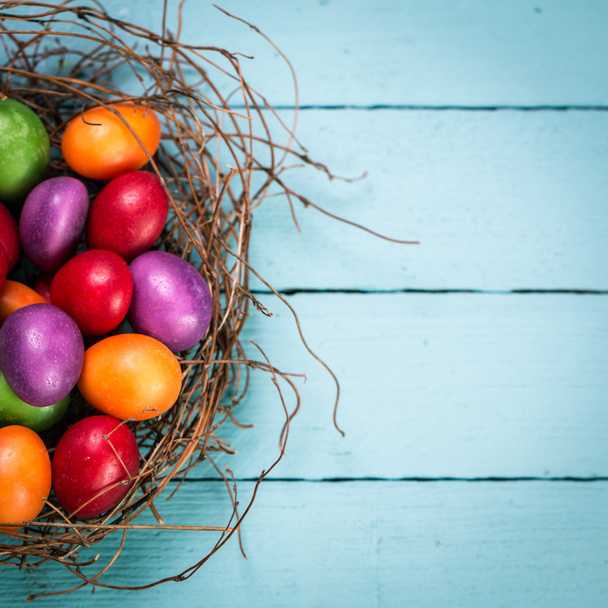 Easter concept with colorful eggs on wooden background - Foto, afbeelding