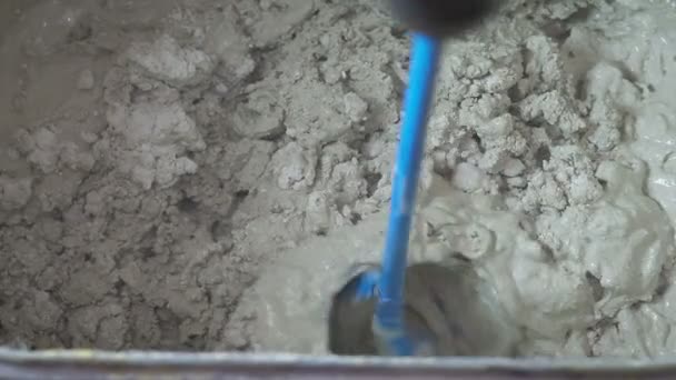 Mixing of a plaster solution by an electric drill. - Imágenes, Vídeo