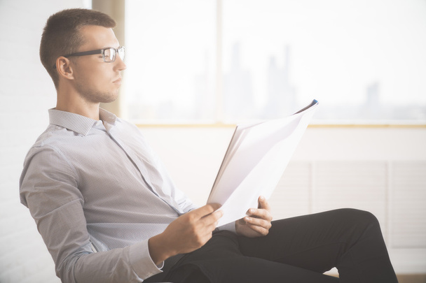 Man in glasses holding paperwork - Photo, Image