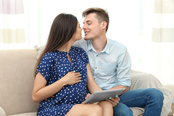 pregnant couple with tablet computer - 写真・画像
