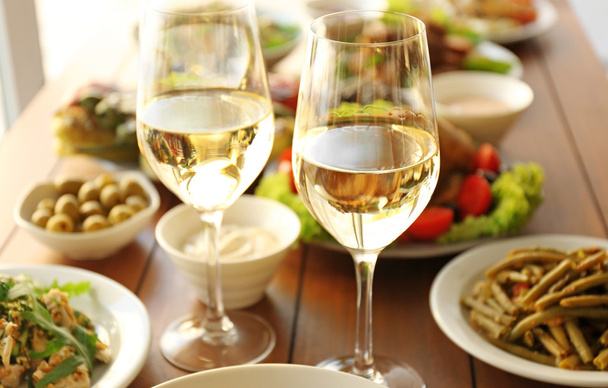 Glasses of white wine on wooden table - Photo, image