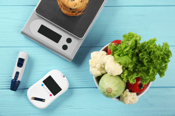 Glucose meter with vegetables and cookies   - Fotó, kép