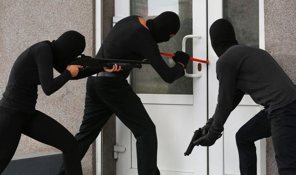 Armed thieves breaking a door - Foto, Imagen