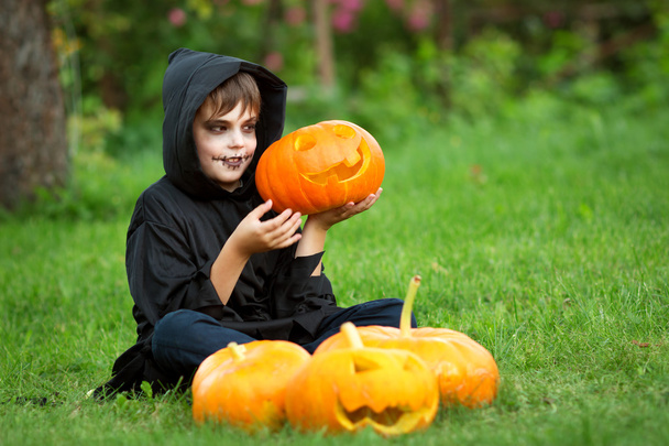 Child in scary costume with pumpkin - Photo, Image