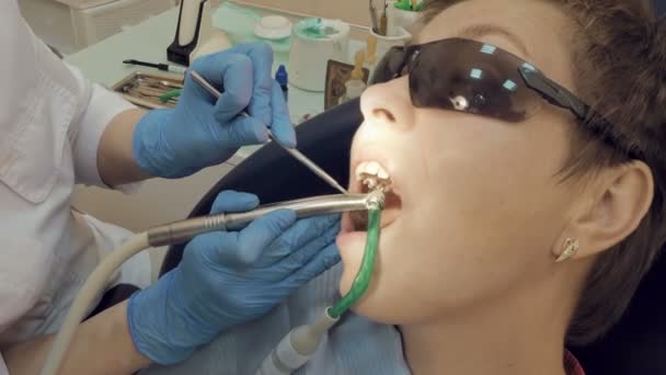 Woman at the dentist medical clinic for treatment - Filmati, video