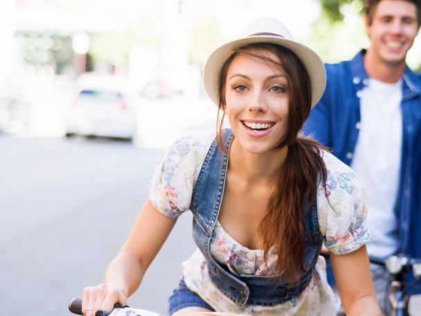 Beautiful woman riding on bike - Zdjęcie, obraz
