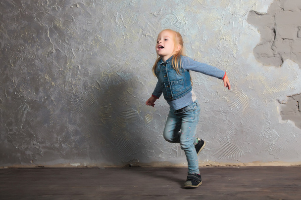 Very happy little girl dancing, jumping, smiling and posing - Fotó, kép