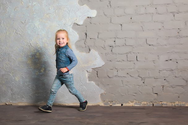 Very happy little girl dancing, jumping, smiling and posing - 写真・画像