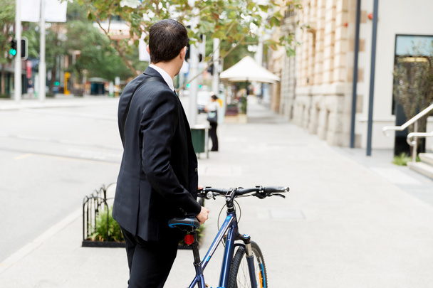 Young businessmen with a bike - Photo, Image